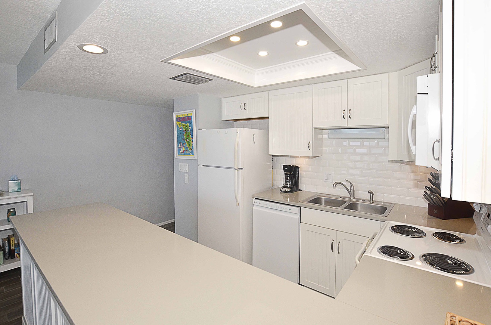 Kitchen updated with custom cabinets, backsplash, and counter tops