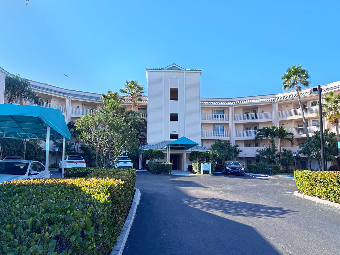 Residence is located in a Resort-style property featuring tropical landscaping and convenient covered parking in a sun-soaked setting.