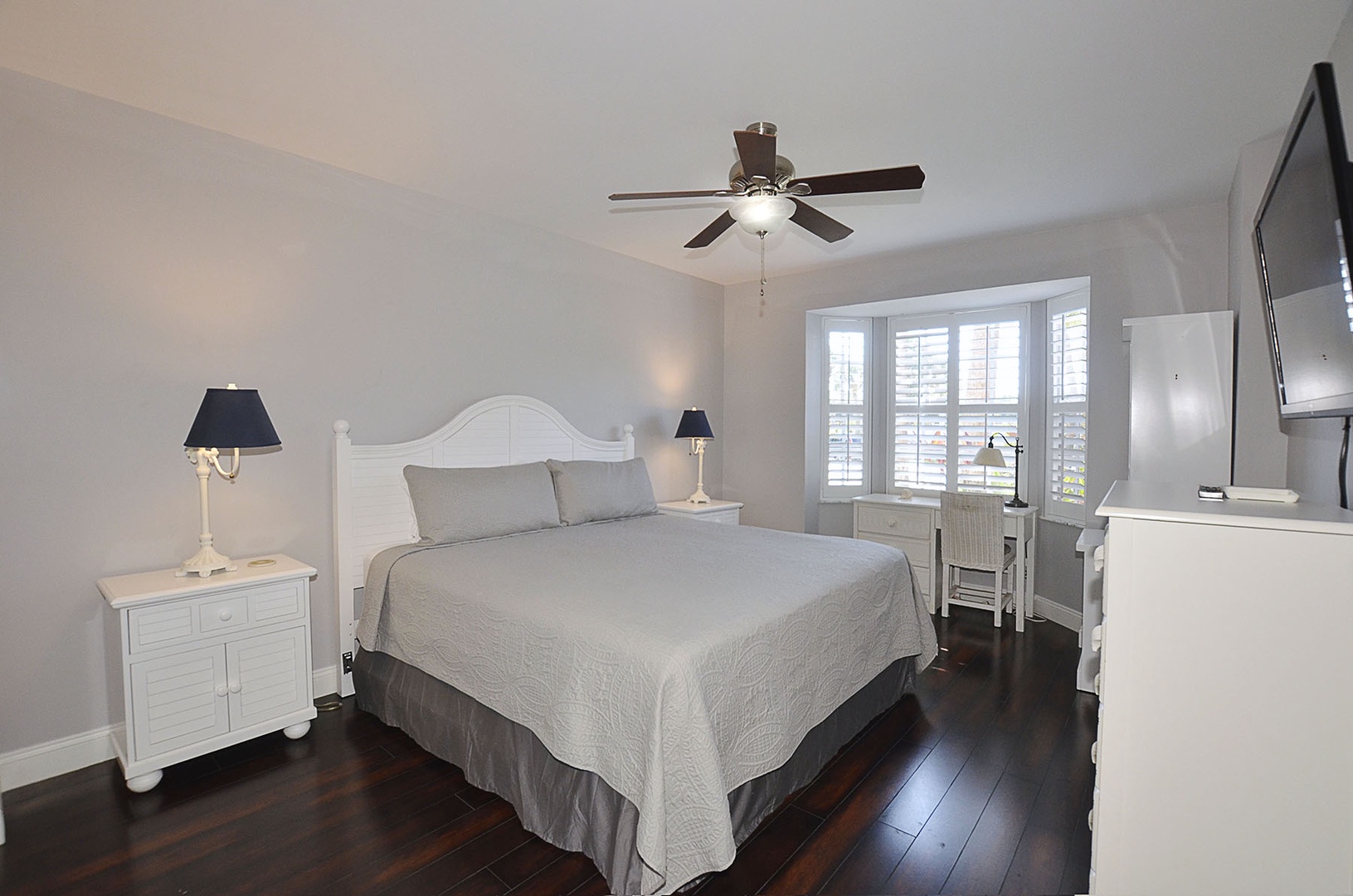 Guest bedroom with ceiling fan creating perfect comfort.