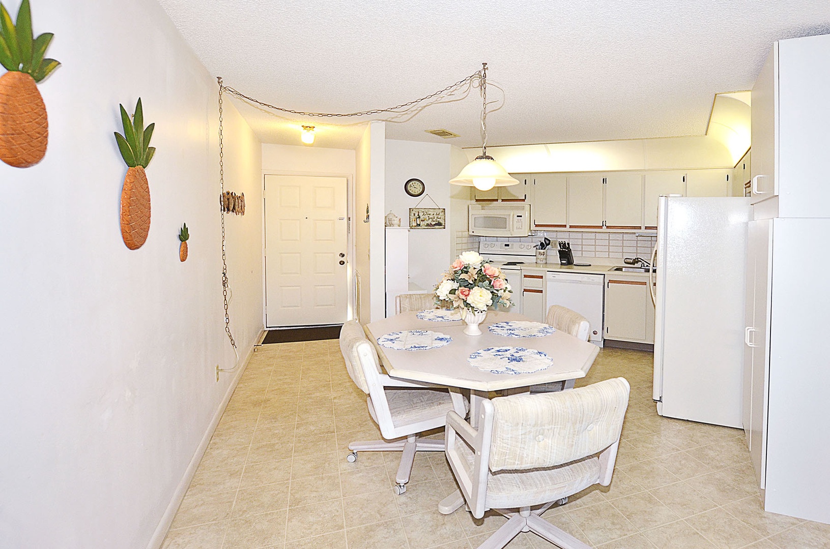 Enjoy meals in your cheerful dining area, complete with tropical pineapple decor and a fully equipped kitchen for all your culinary needs.