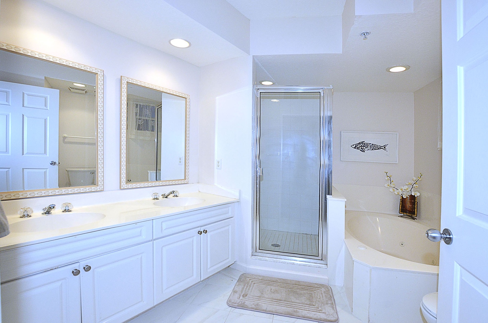 Unwind in your pristine Primary Bedroom ensuite Bathroom with dual vanities, a relaxing soaking tub, and bright glass shower.