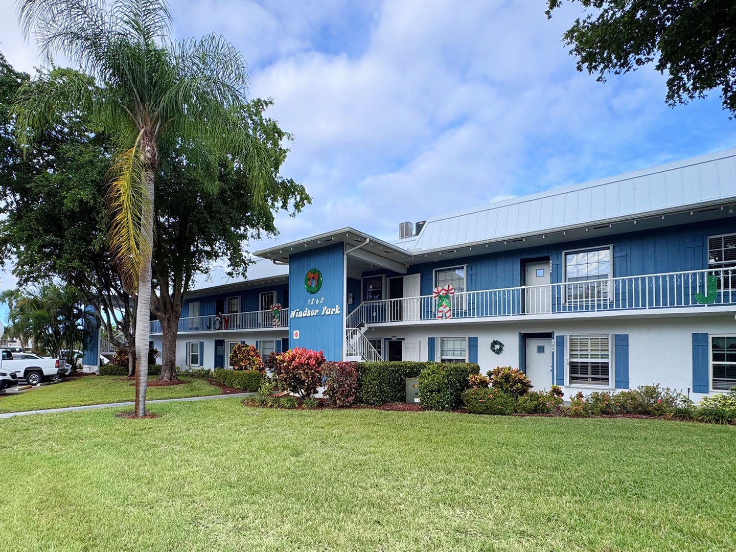 Charming two-story property with tropical landscaping.