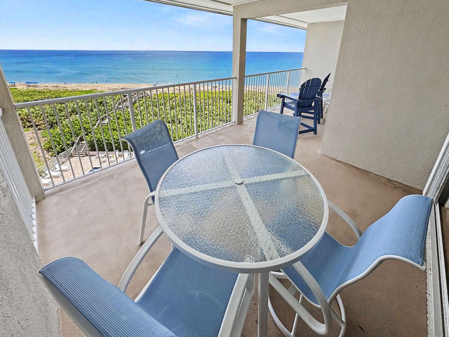 Balcony dining for four overlooking the oceanfront activity