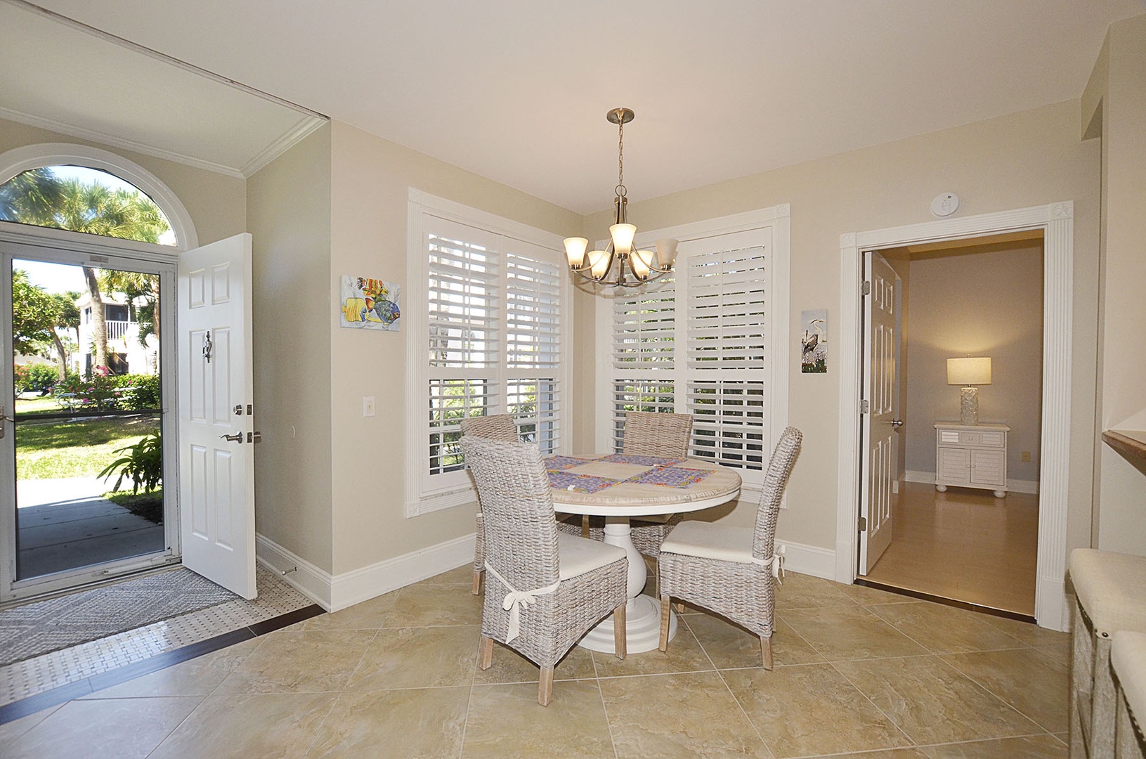 Dining Area. Enjoy intimate meals in your bright dining nook, where wicker chairs circle a mosaic table beneath warm pendant lighting.