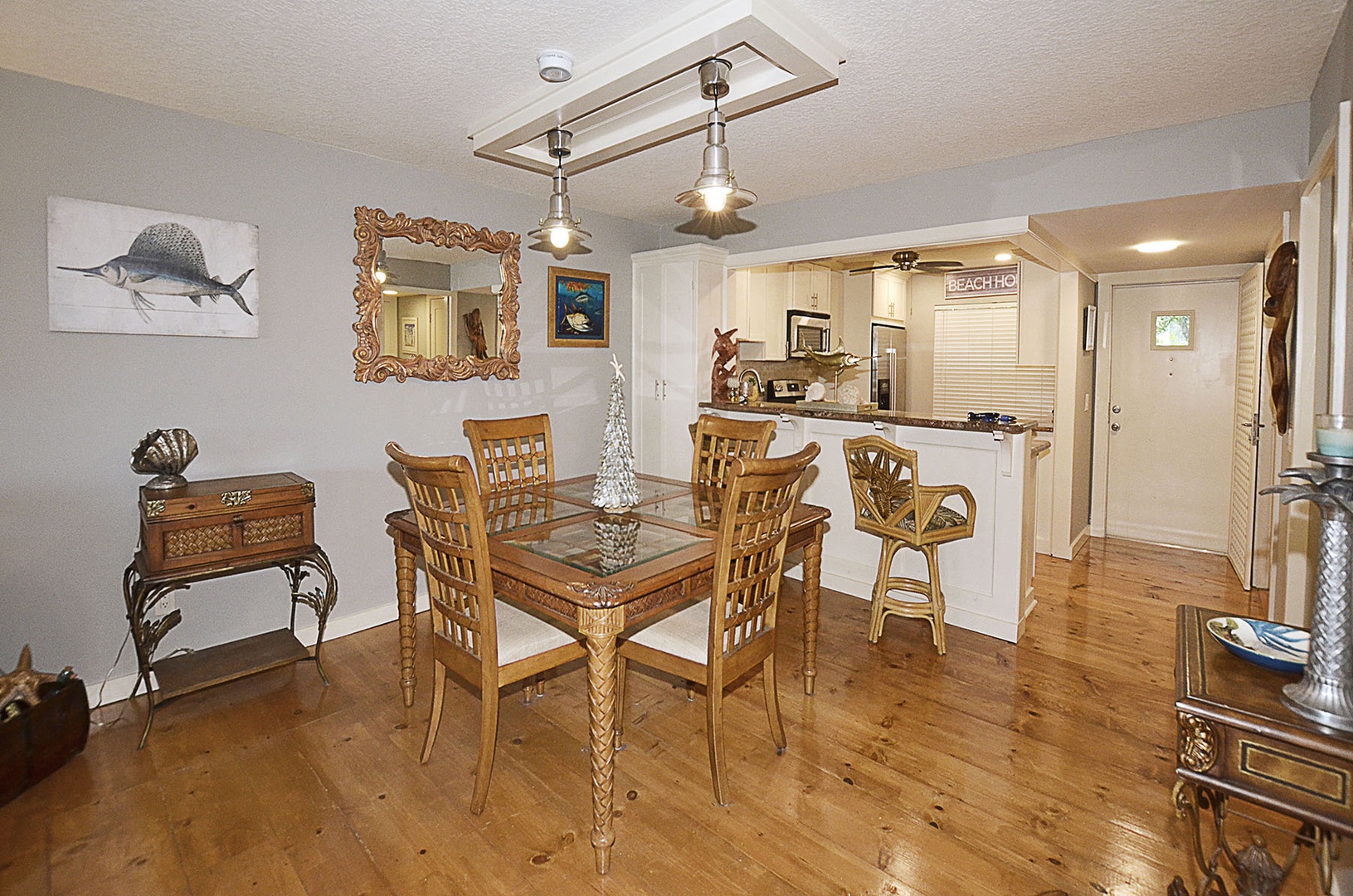 Dining Area. Your elegant dining space features a beautiful glass table with coastal charm, opening seamlessly to the fully equipped kitchen.
