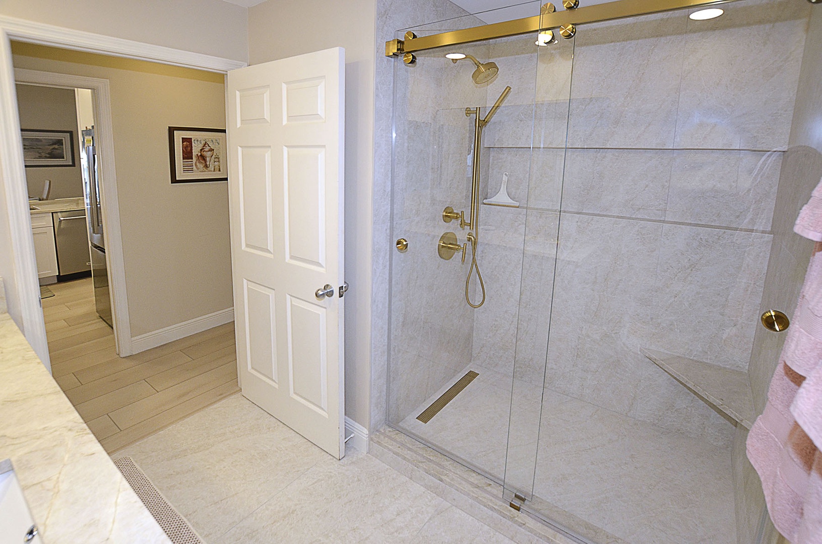 Guest Bathroom. Luxurious marble shower with golden fixtures awaits your rejuvenating morning routine.