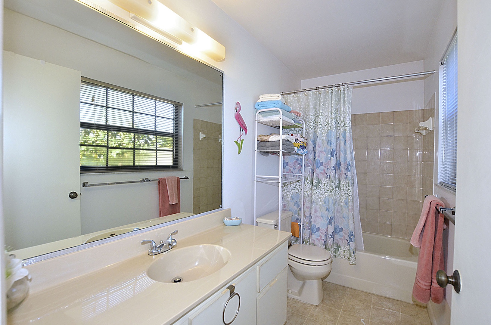 Your bathroom offers bright vanity lighting, spacious tub-shower combo, and convenient towel storage—perfect for refreshing after busy days.