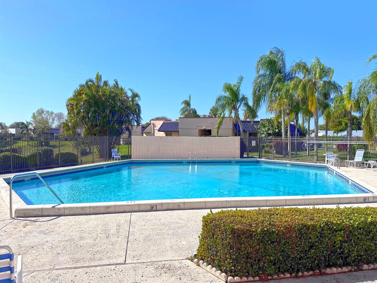 Take a refreshing dip in this sparkling blue pool surrounded by tropical palms and comfortable poolside seating.