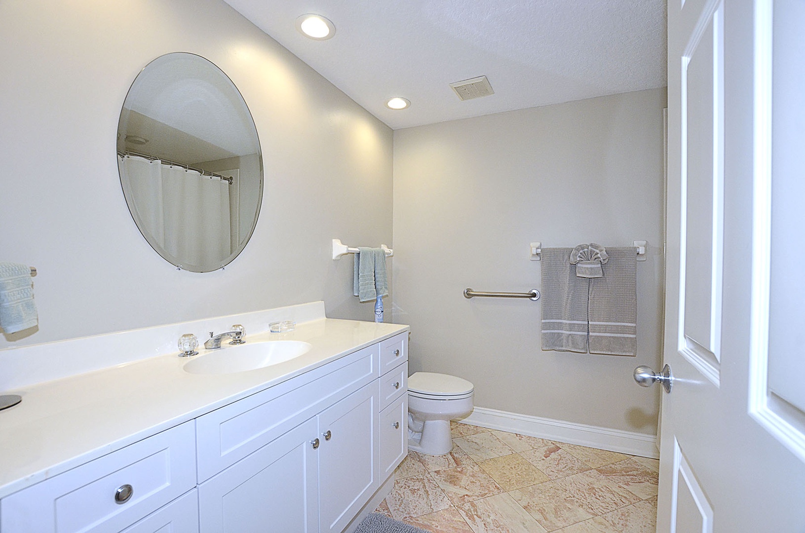 Guest bathroom featuring white cabinetry, marble flooring, and recessed ceiling lighting.