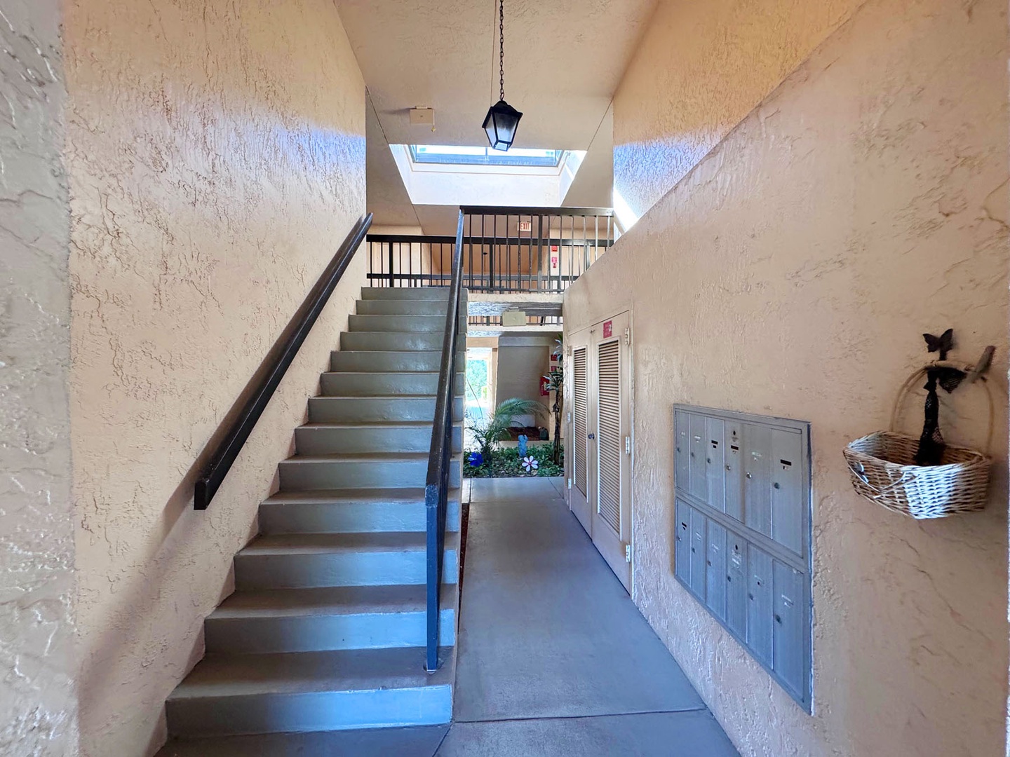 Step into a bright, welcoming stairwell with natural light streaming through the skylight above your comfortable stay.