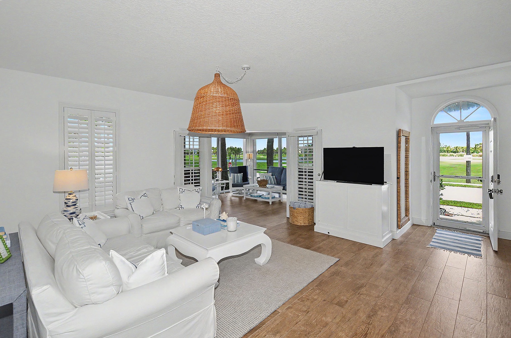 Spacious living room with direct access to corner screened patio.