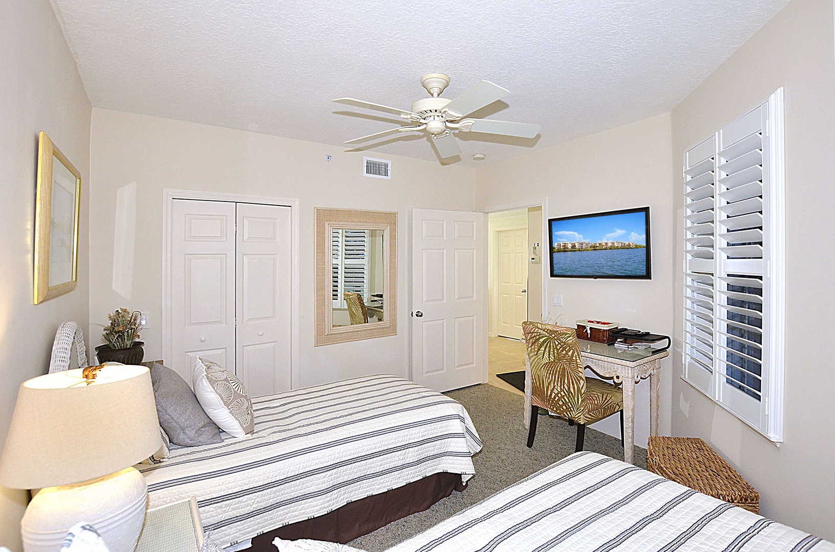 Your coastal bedroom features twin beds with crisp linens, a work desk, and mounted TV for your comfort.