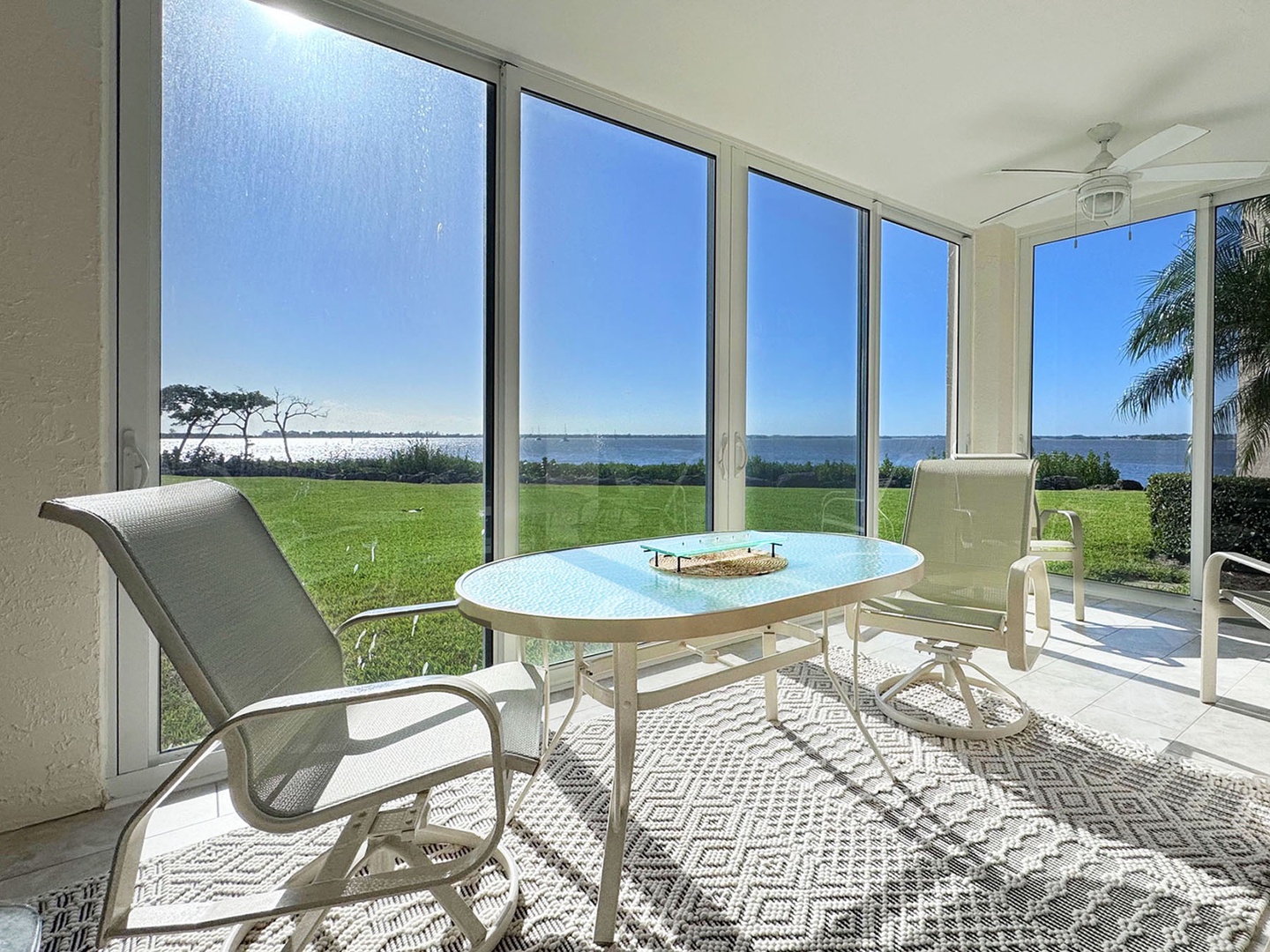 Your glass enclosed & screened lanai Patio frames breathtaking wide water views, creating the perfect spot for morning coffee while watching boats drift by.
