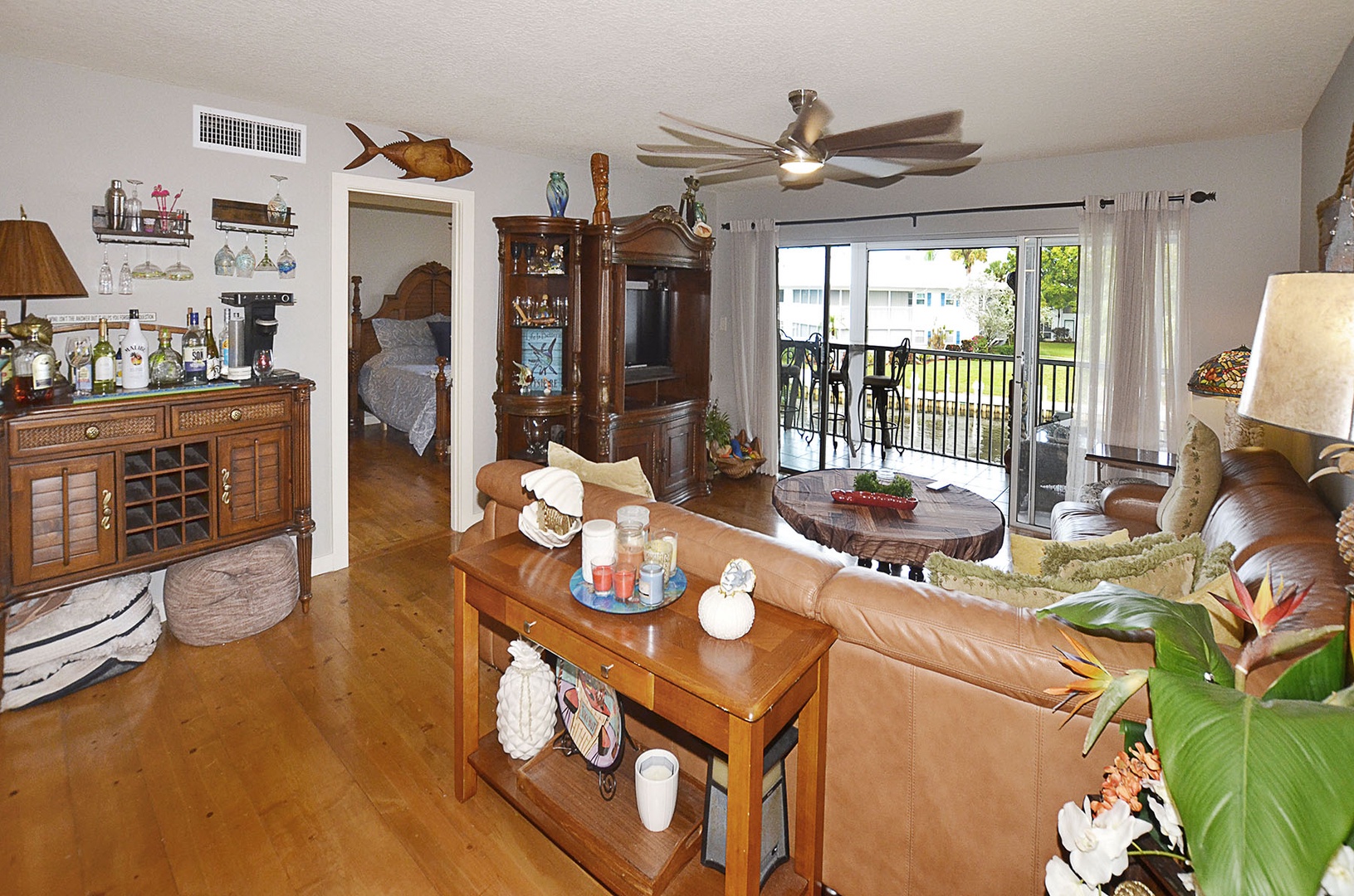 Living Room. Relax in your spacious living area with warm wood furnishings and a peaceful balcony where you can unwind.