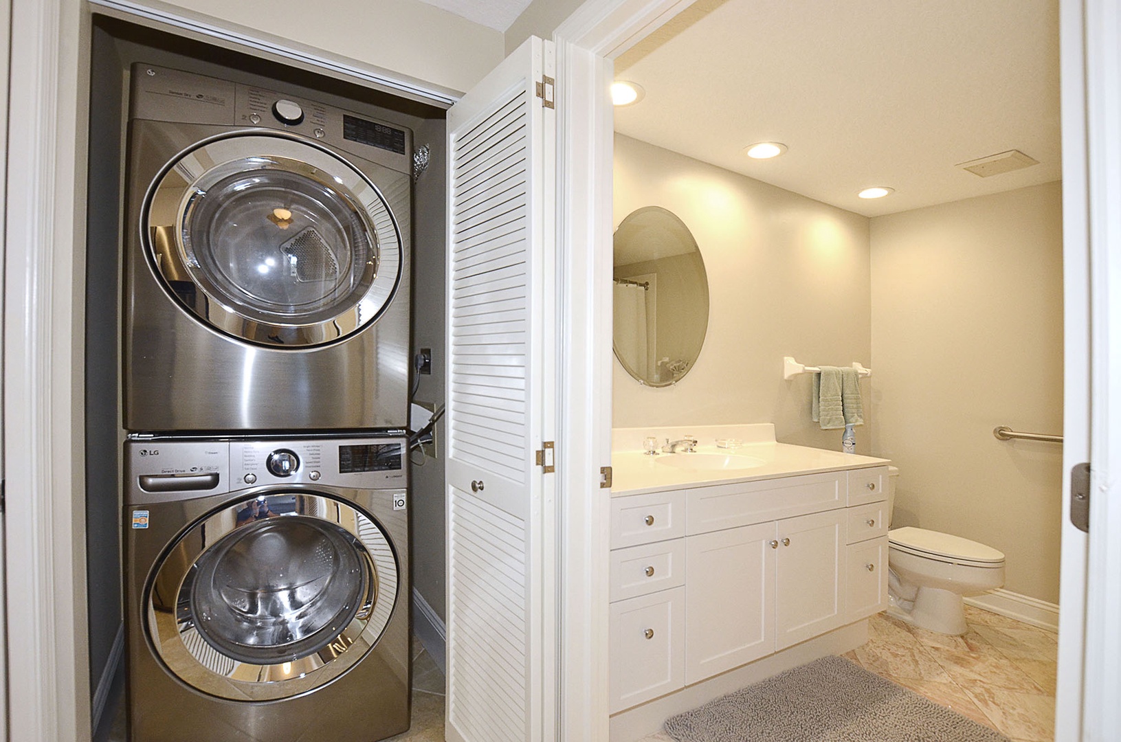 Hallway laundry closet with stacked washer and dryer.