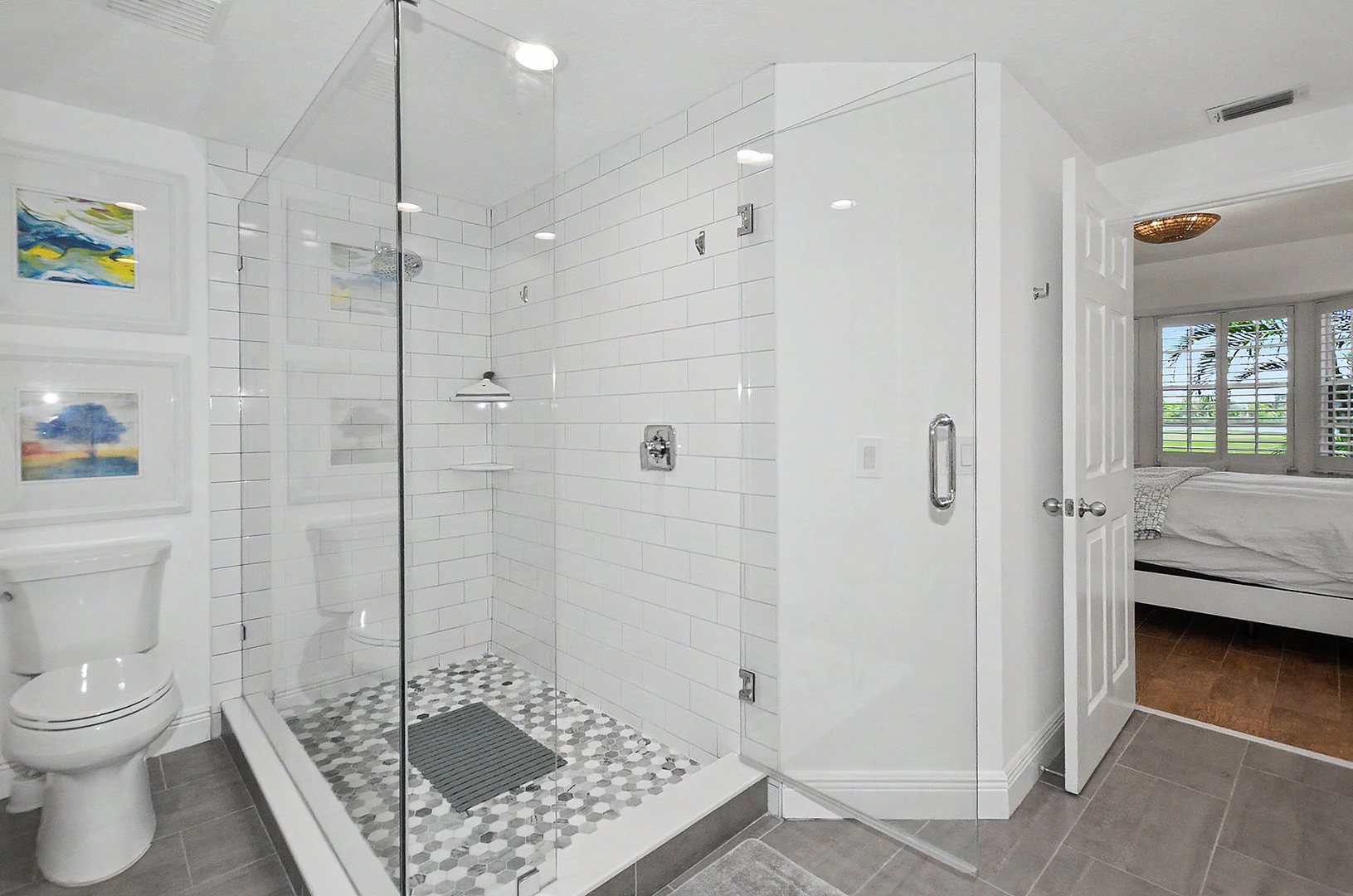 Primary bathroom with glass enclosed shower.