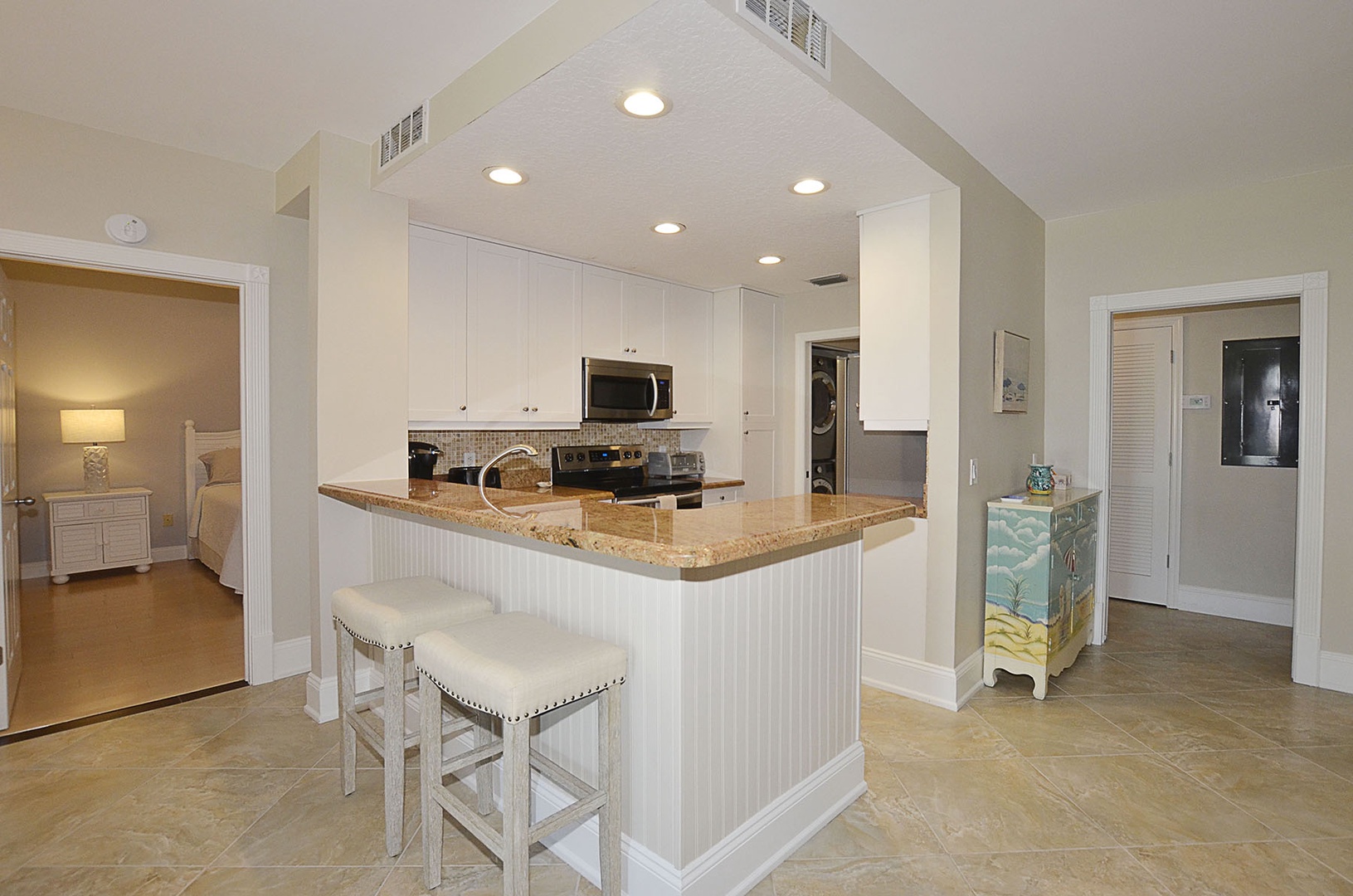 Kitchen with granite counters and island seating—perfect for morning coffee or evening conversations.