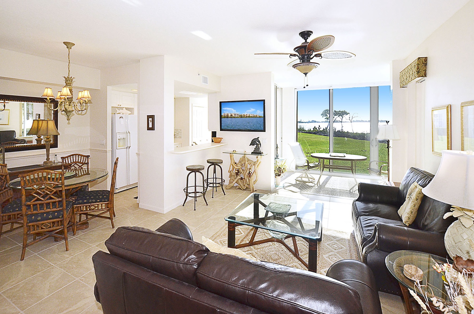 Relax in your bright, open living space with leather sofas, garden  and waterfront views, and a seamless flow to your private balcony.