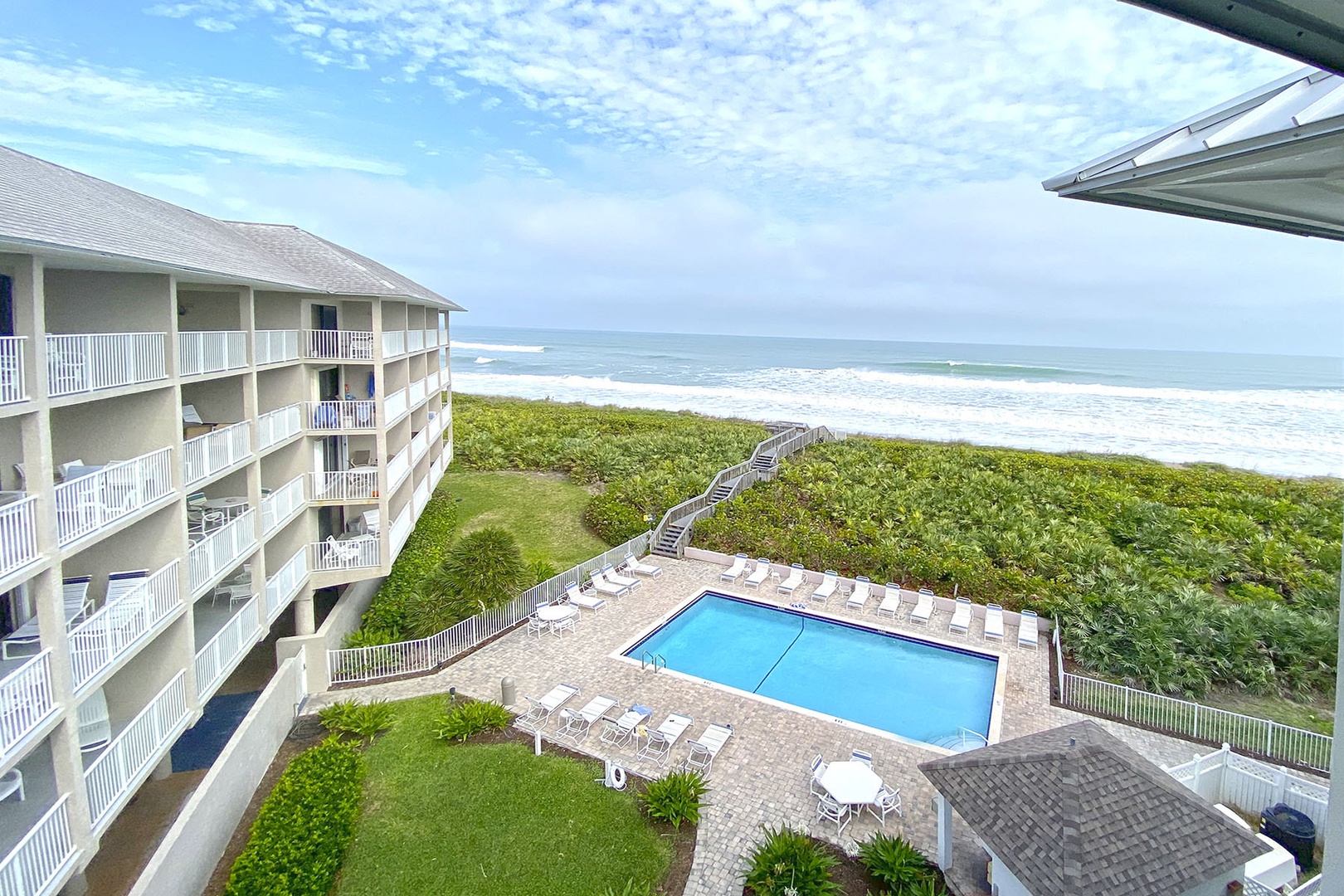 Balcony view overlooking community swimming pool & ocean dune crossing