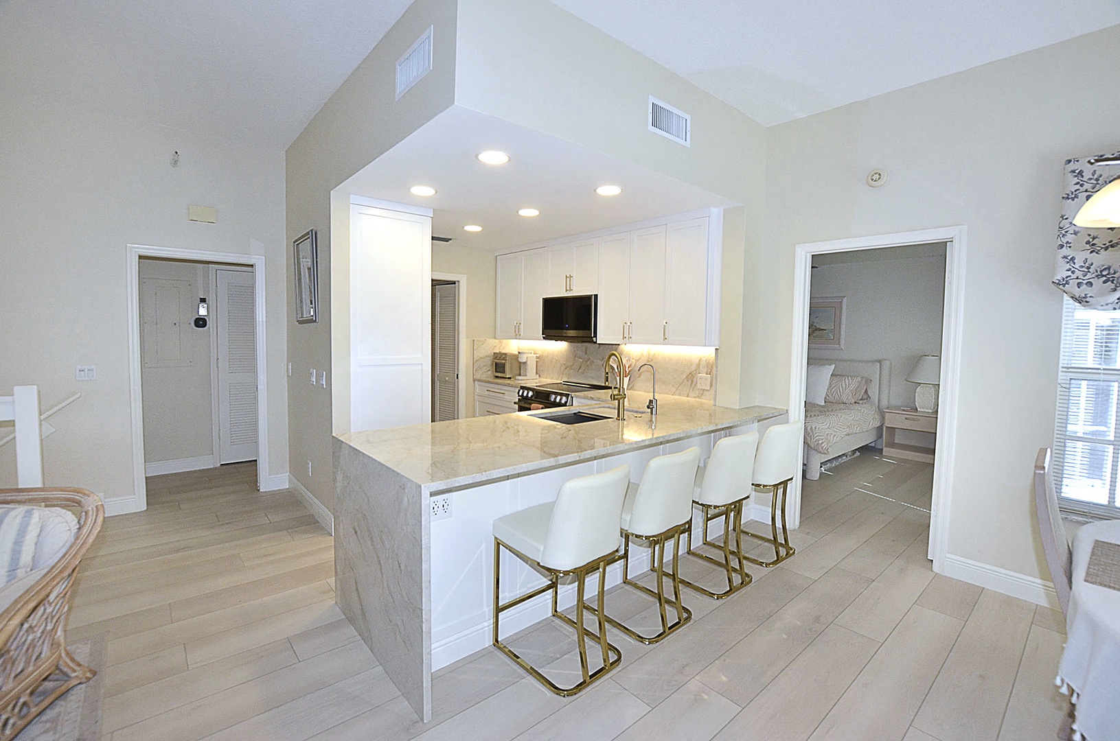 Kitchen. Your modern kitchen island becomes the heart of your vacation home, where marble countertops and sleek bar seating invite memorable meals together.