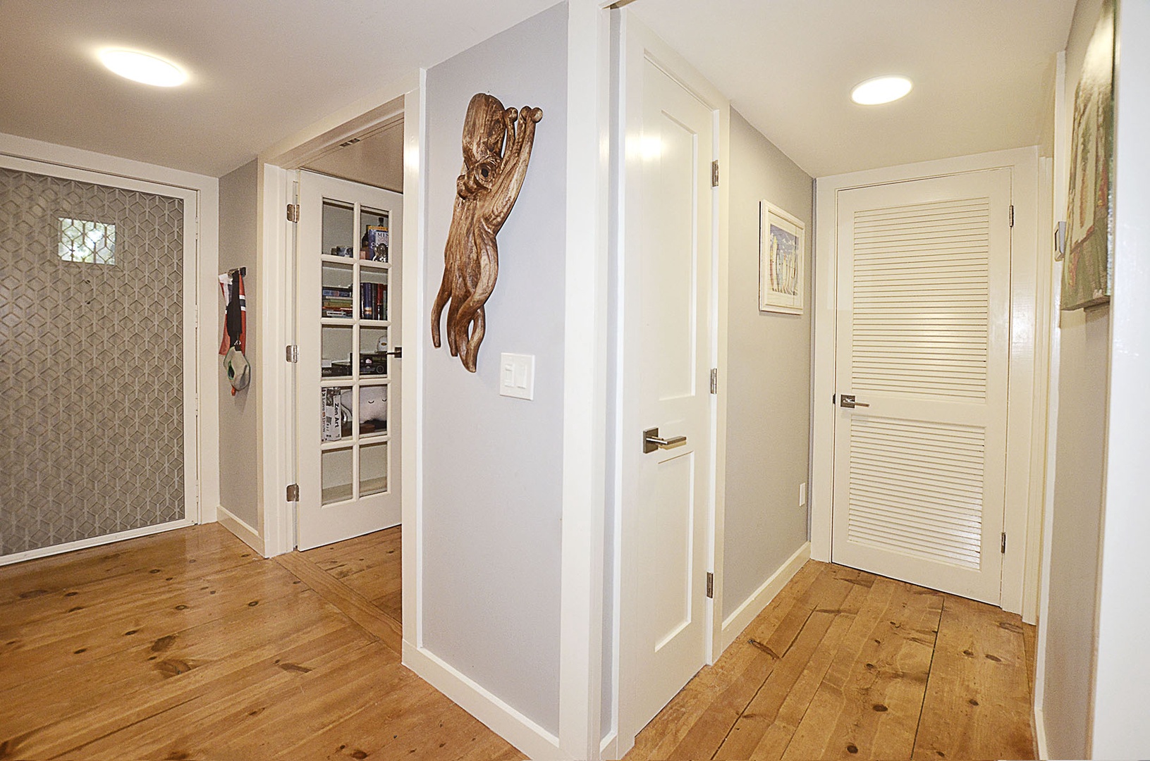 Entry Foyer. Step into your stylish hallway where warm wood floors meet elegant white doors, creating a welcoming flow throughout your retreat.