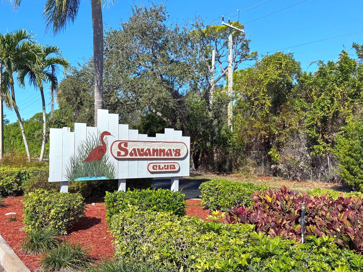 Welcome to Savannas Club, where tropical paradise meets comfort in this beautifully landscaped Florida community entrance.