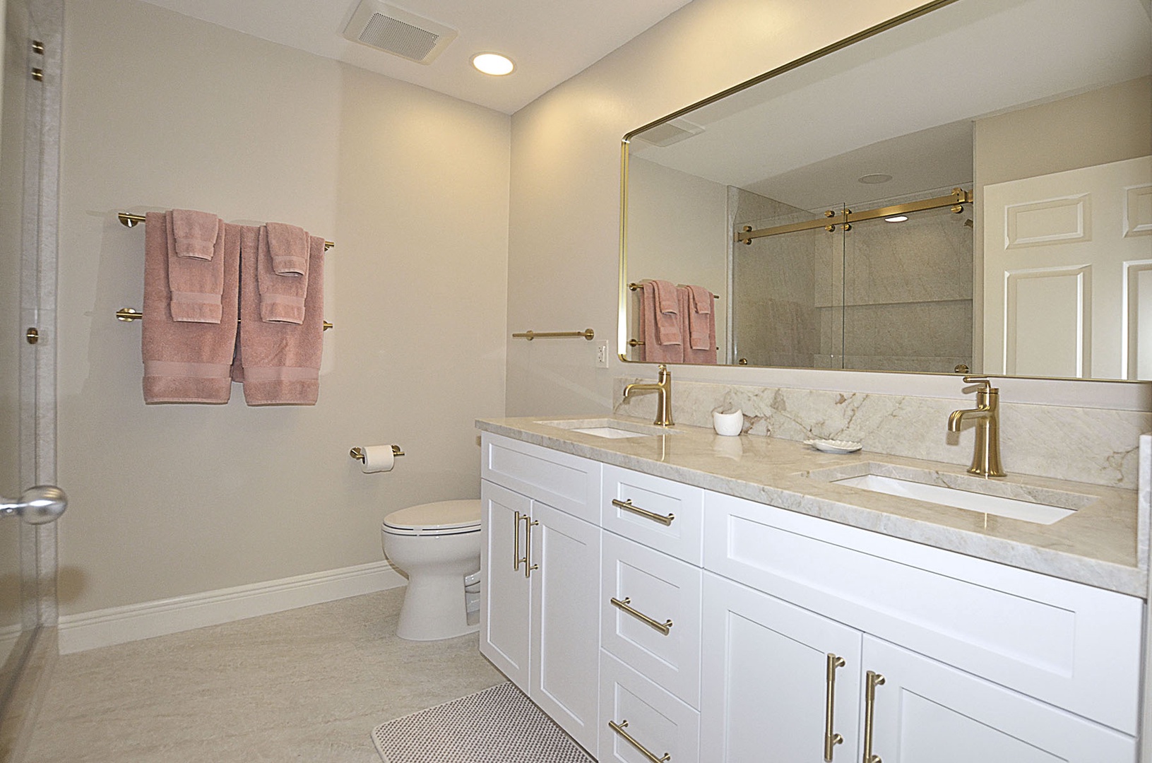 Guest Bathroom.  Indulge in private spa-like bathroom with elegant marble counters, dual sinks, and luxurious finishes for ultimate relaxation.