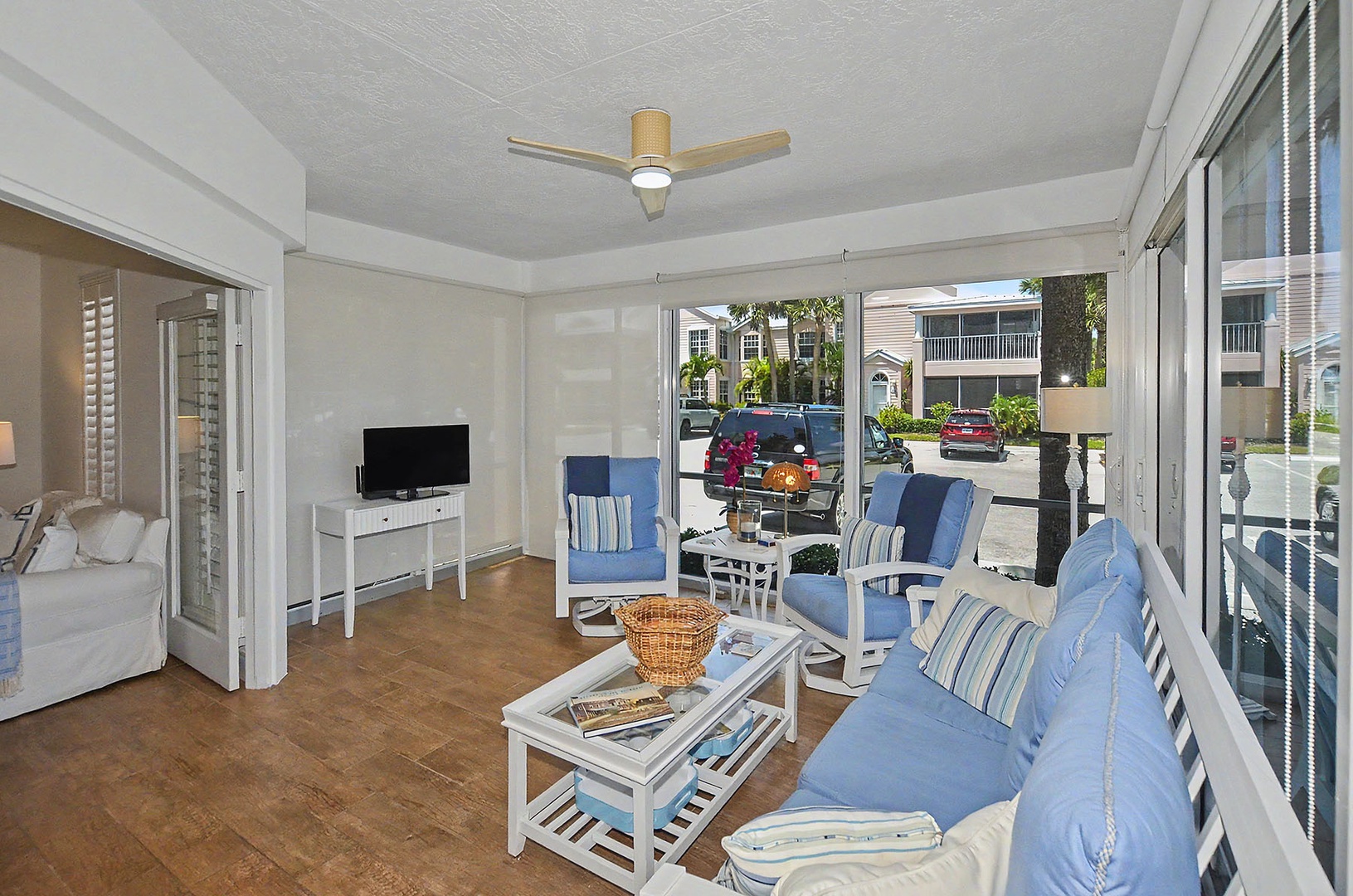 Covered screened patio with comfortable seating.