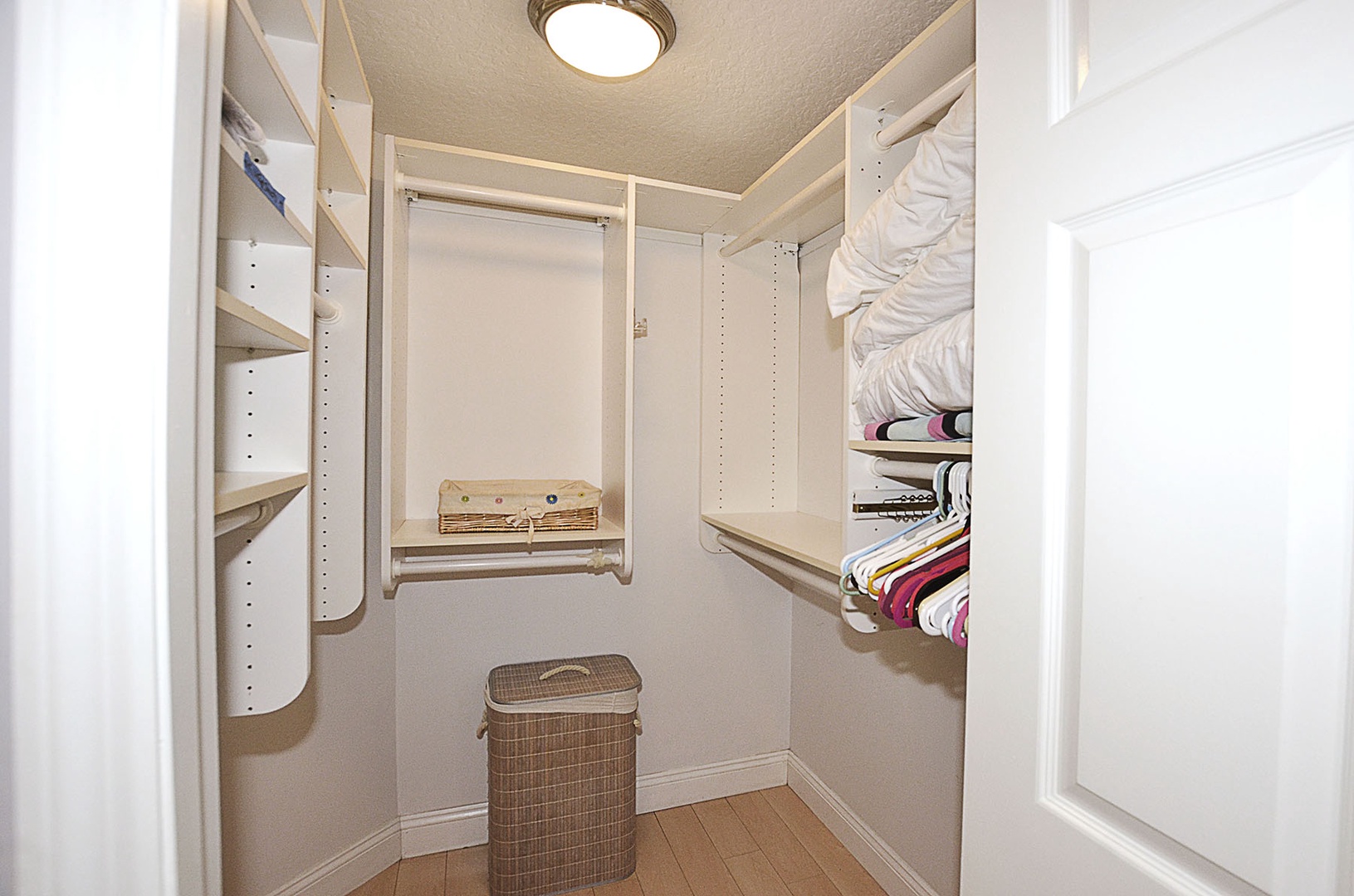 Main bedroom includes a spacious walk-in closet offering organized storage with adjustable shelving and hanging rods to keep your belongings perfectly arranged during your stay.
