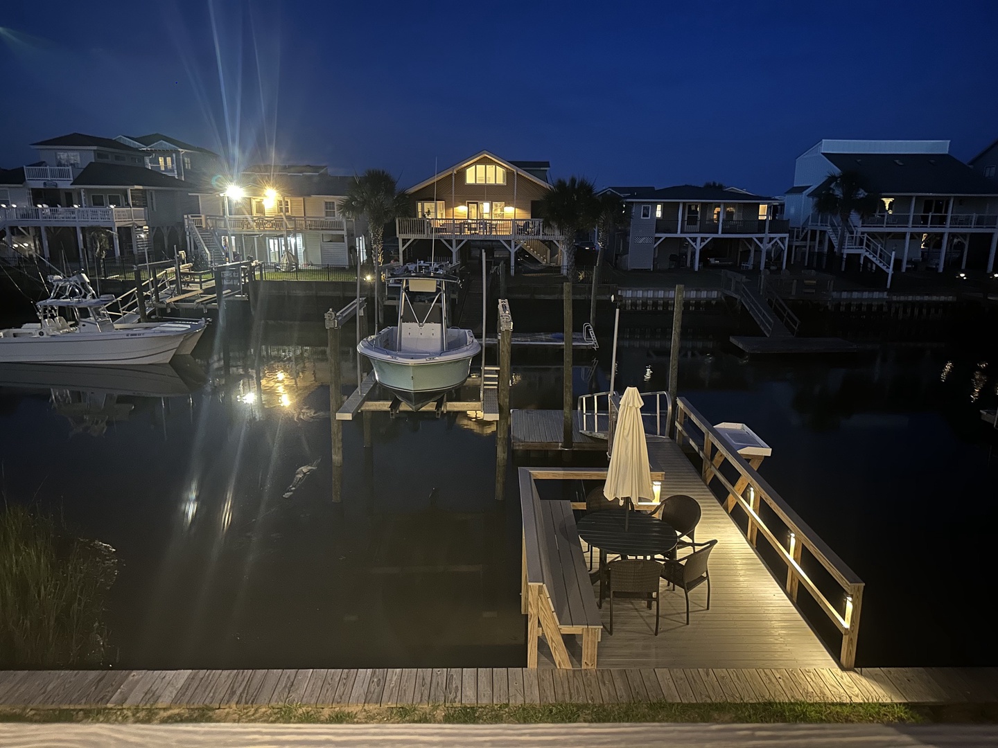 Dock with table & chairs at night from deck