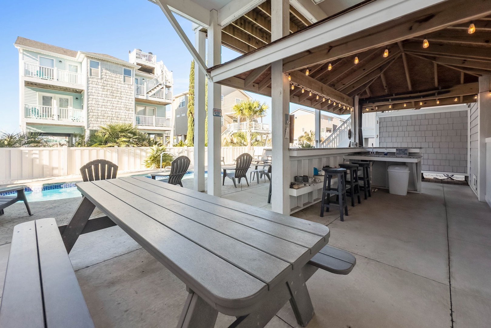 picnic table and tiki bar poolside