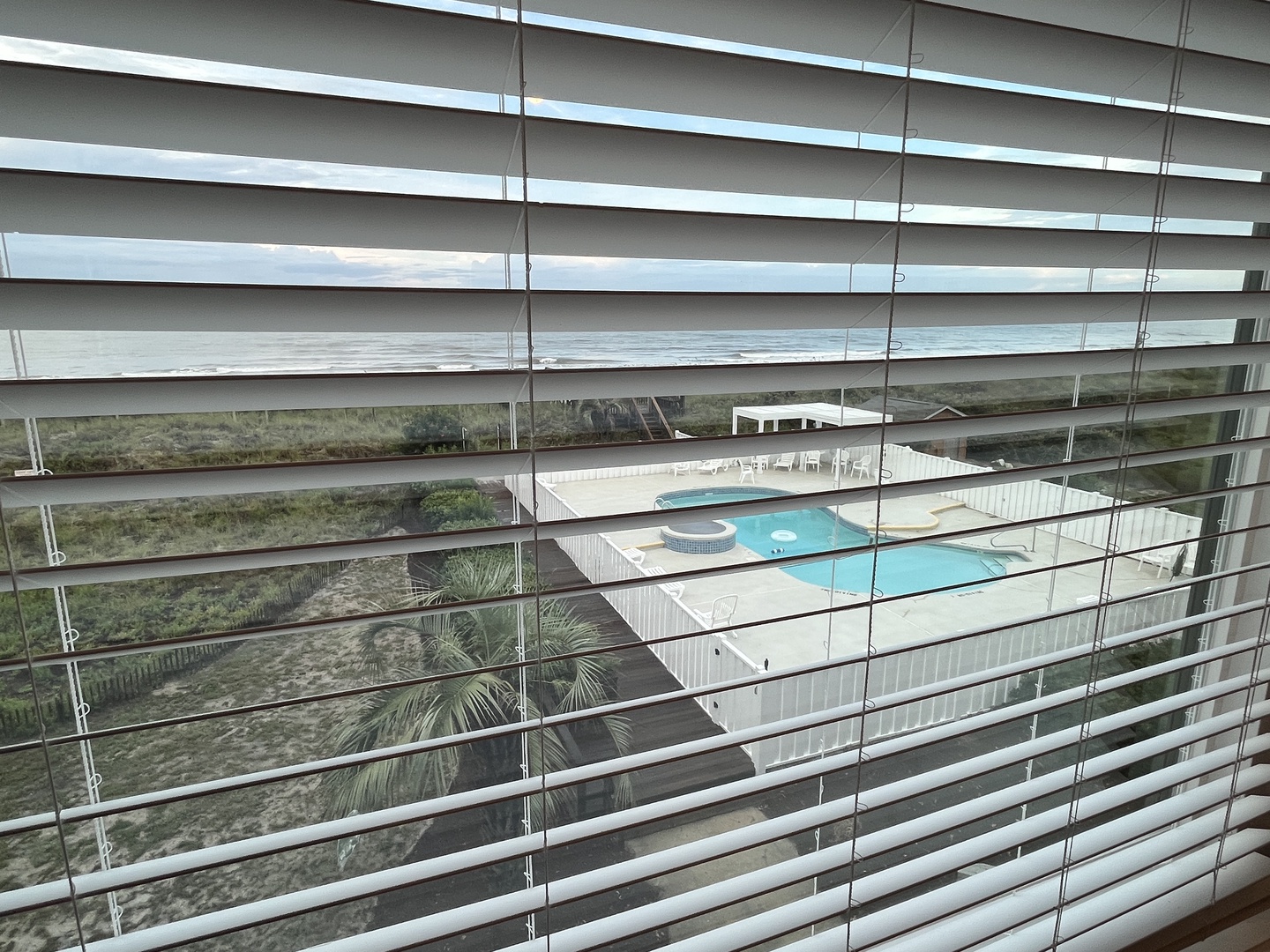 view of pool from oceanfront bedroom