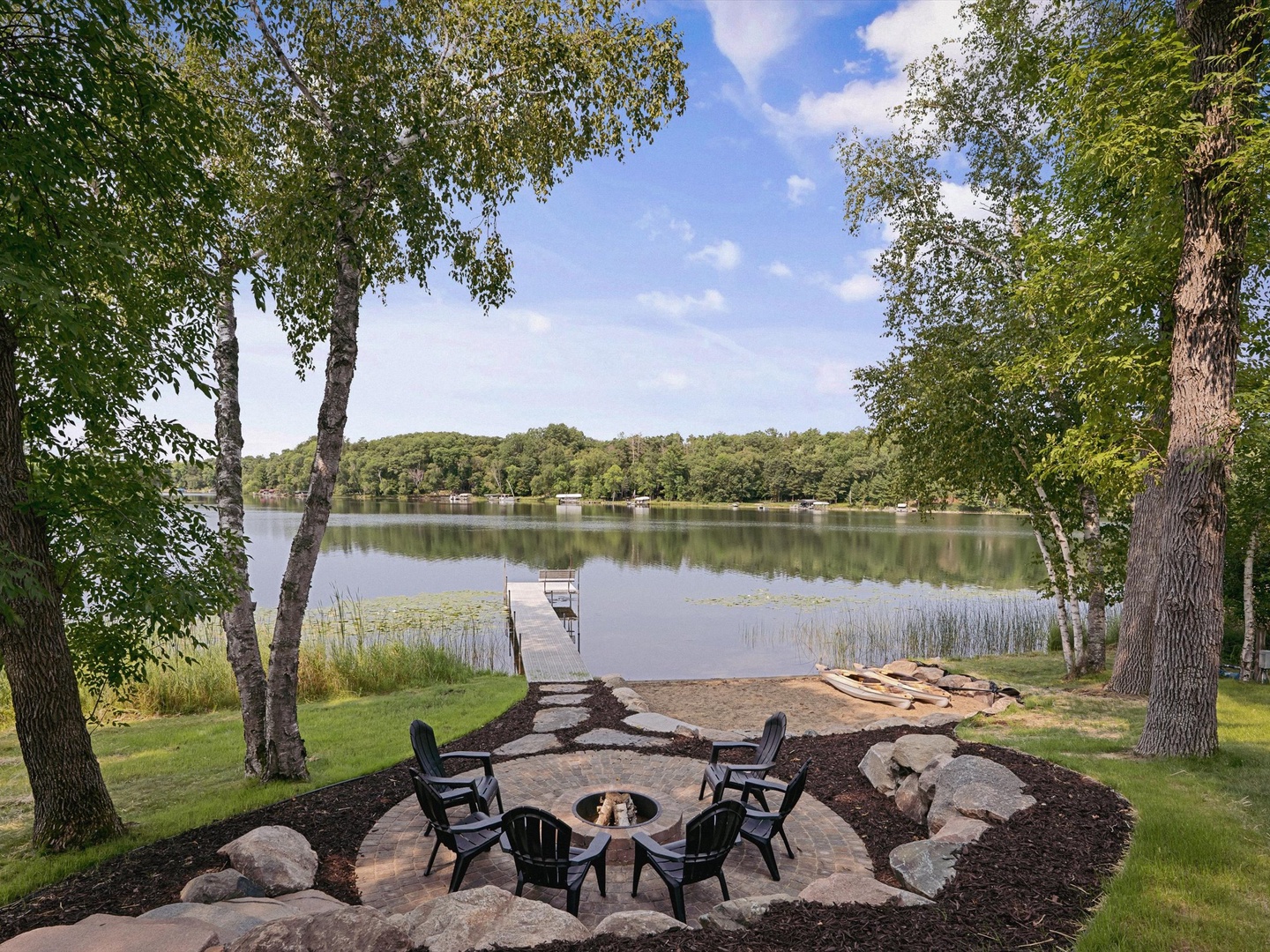 Landscaped fire pit, beach & dock.