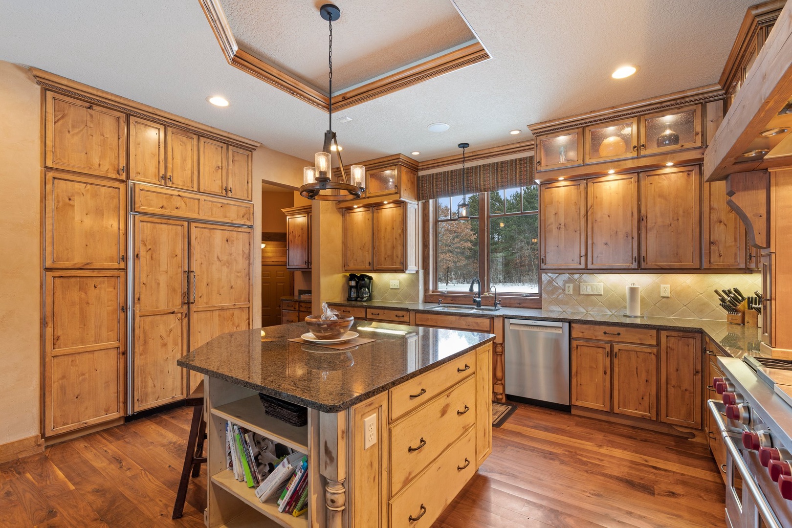 Your gourmet kitchen awaits with warm wood cabinets, granite countertops, and premium appliances for memorable meal preparation.