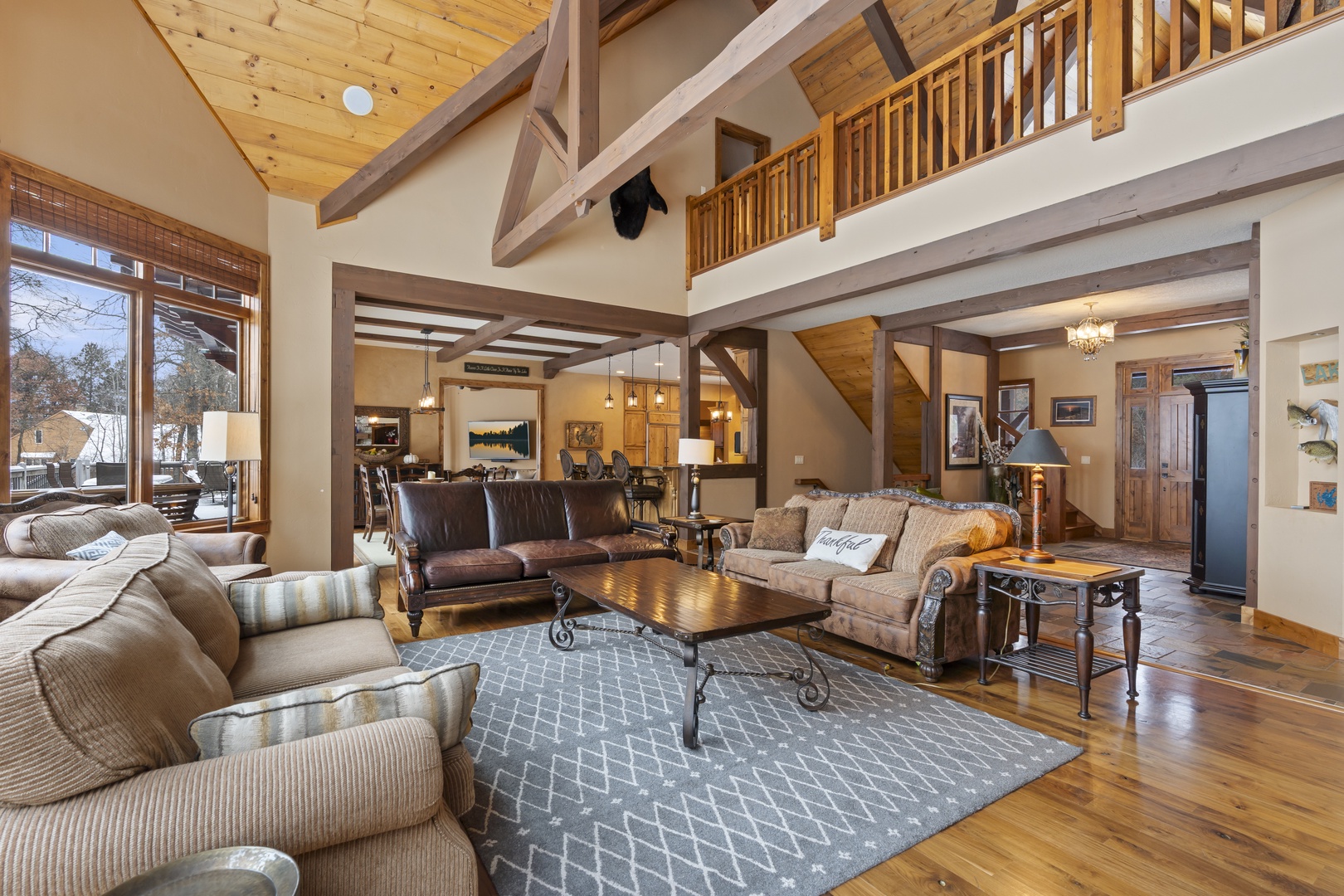 Relax in your spacious living room with soaring ceilings, exposed beams, and comfortable seating for memorable mountain moments.