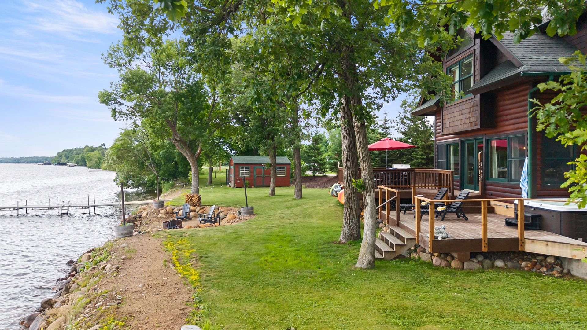 Spacious deck and backyard close to water.