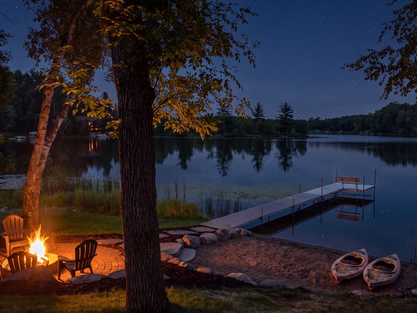 Lakeside fire pit, dock & beach at twilight.