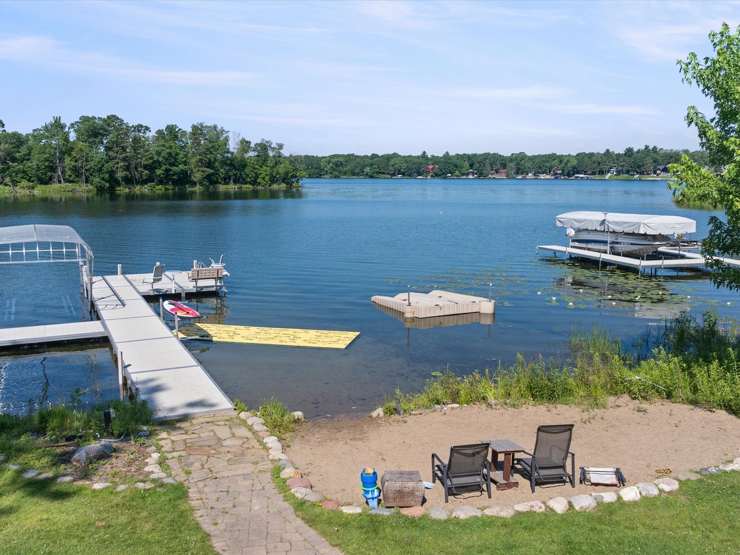 View of beach, lake and dock.