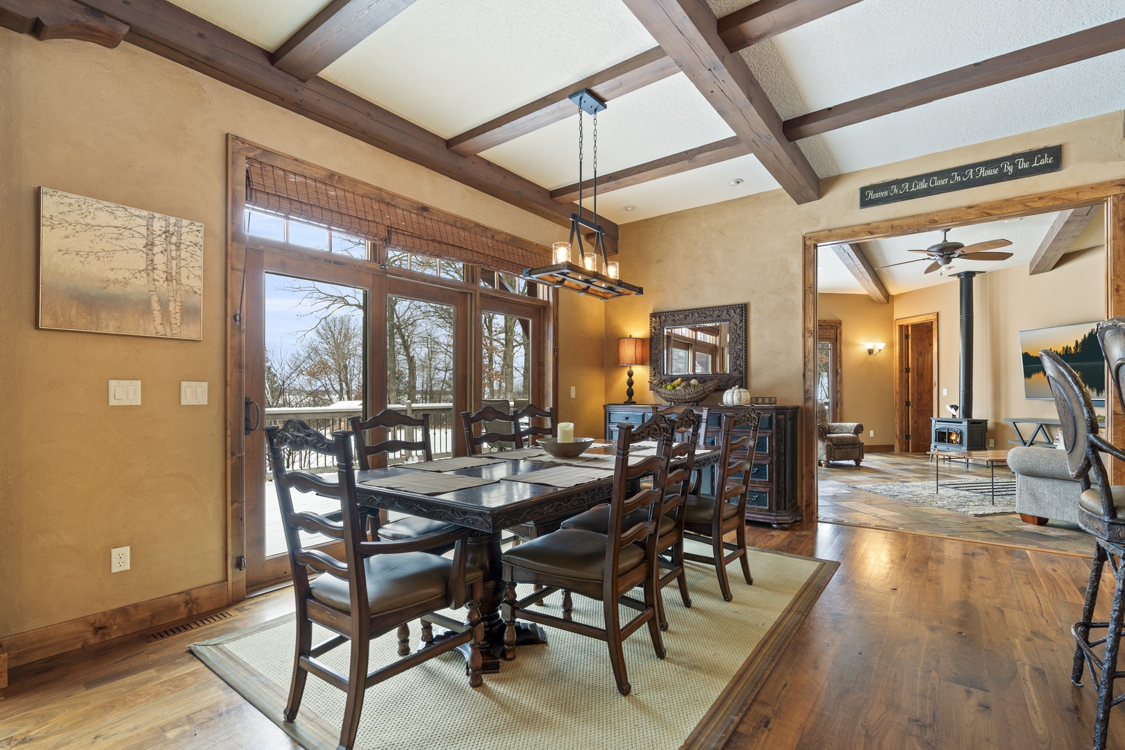 Your elegant dining space features rustic wooden beams overhead, warm natural light, and opens seamlessly to a welcoming living area for memorable meals.