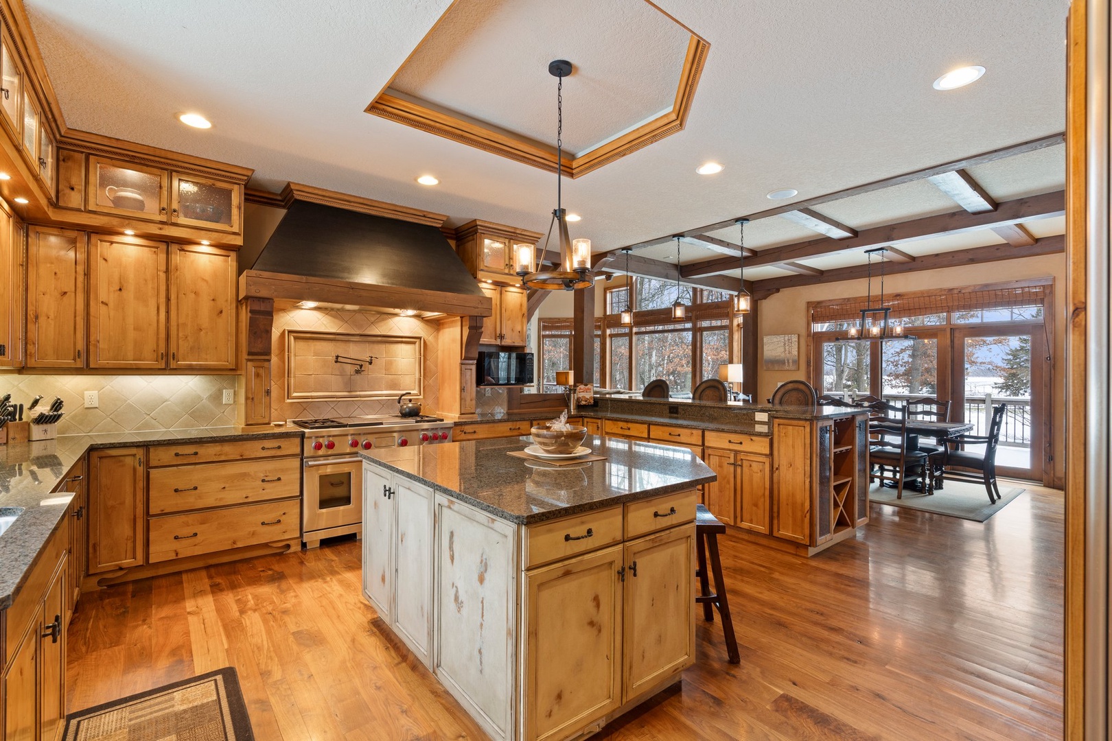 Your gourmet kitchen features rich wood cabinetry, granite countertops, and professional appliances perfect for creating memorable meals together.