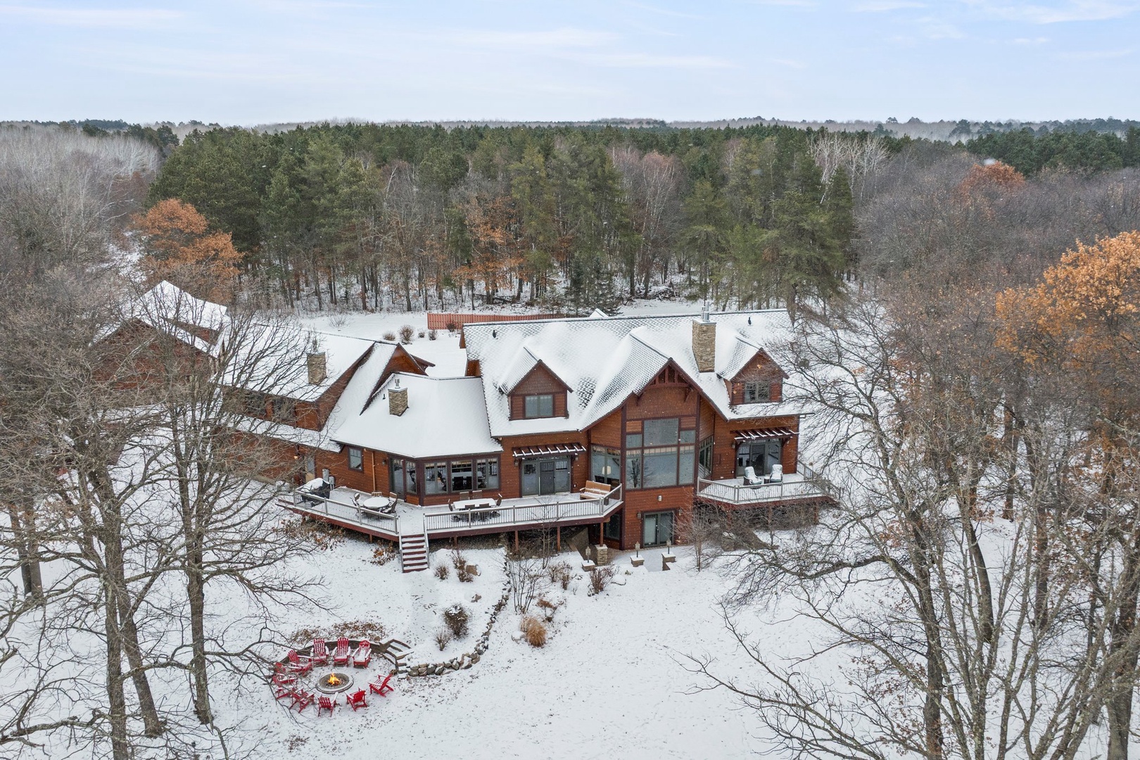 Stunning winter retreat nestled in pristine forest surroundings with expansive decking and charming seasonal ambiance.