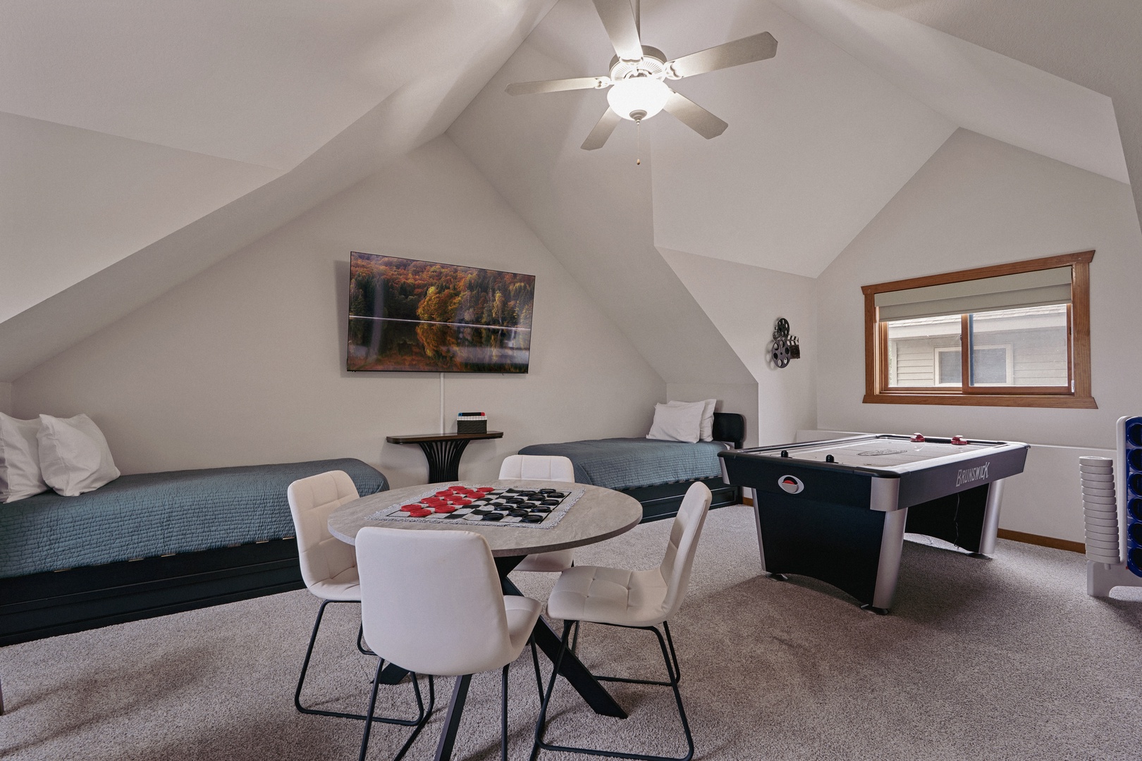 Large upper level game room with sleeping quarters.