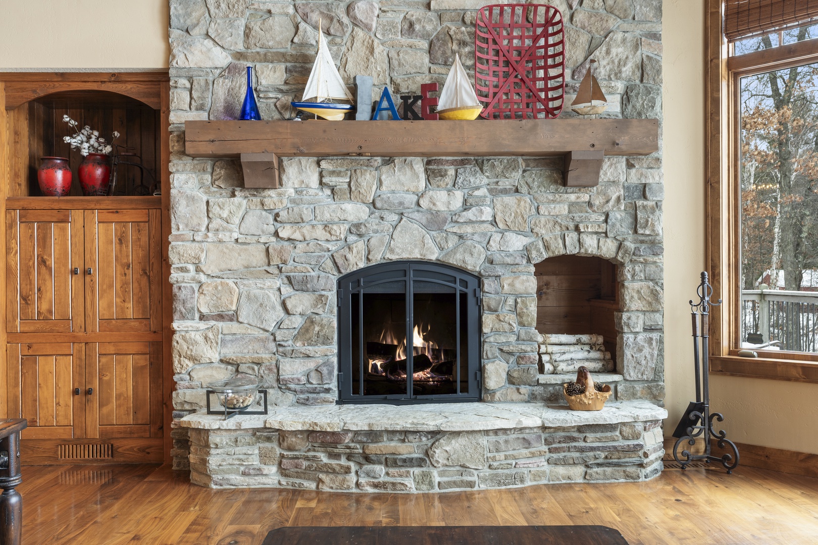Gather around this stunning stone fireplace where crackling flames create the perfect ambiance for your cozy evening conversations.