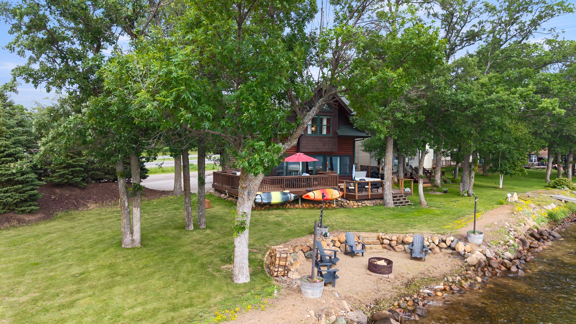 Side view of property, deck, fire pit and outdoor seating.