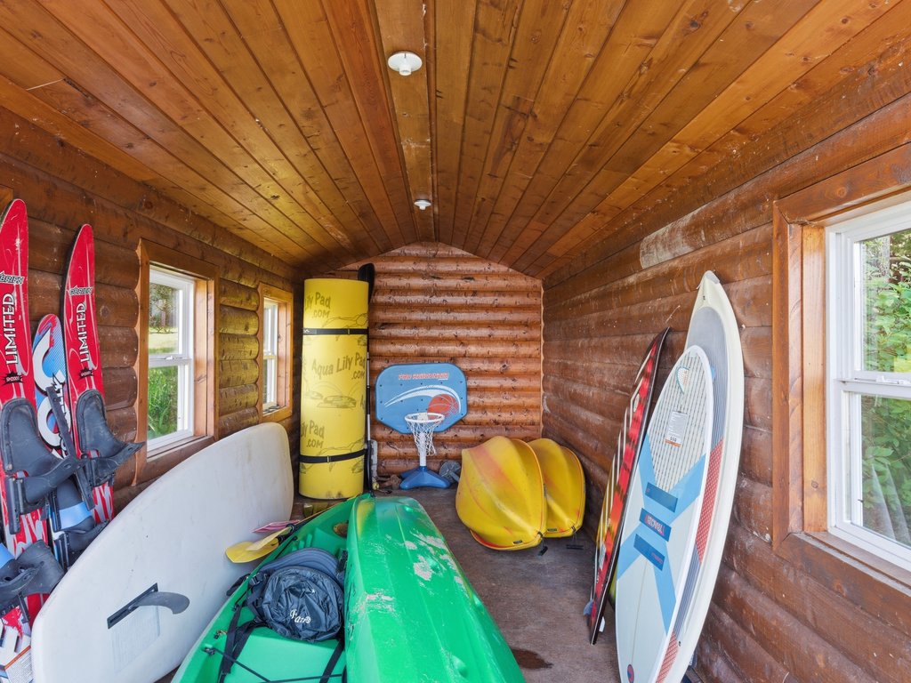 Boathouse serves as storage, housing kayaks, paddleboards, water toys and life jackets.