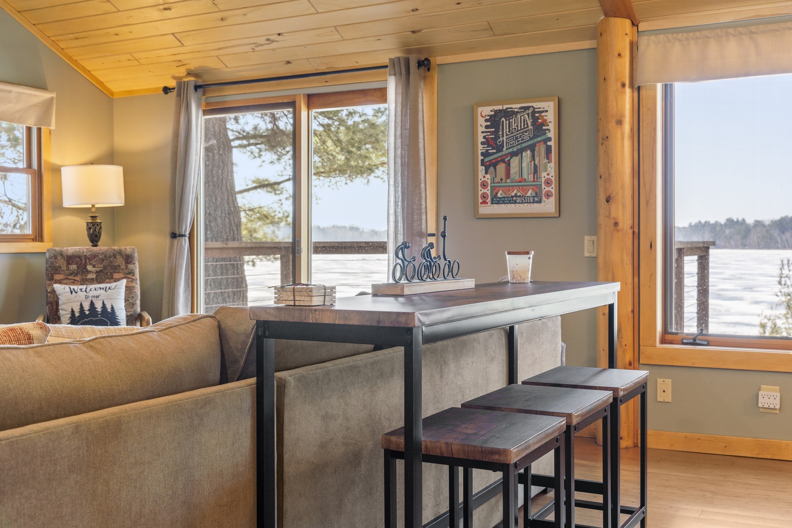 Unwind in your cozy lakefront retreat where rustic wood beams meet modern comfort, perfect for morning coffee with stunning water views.