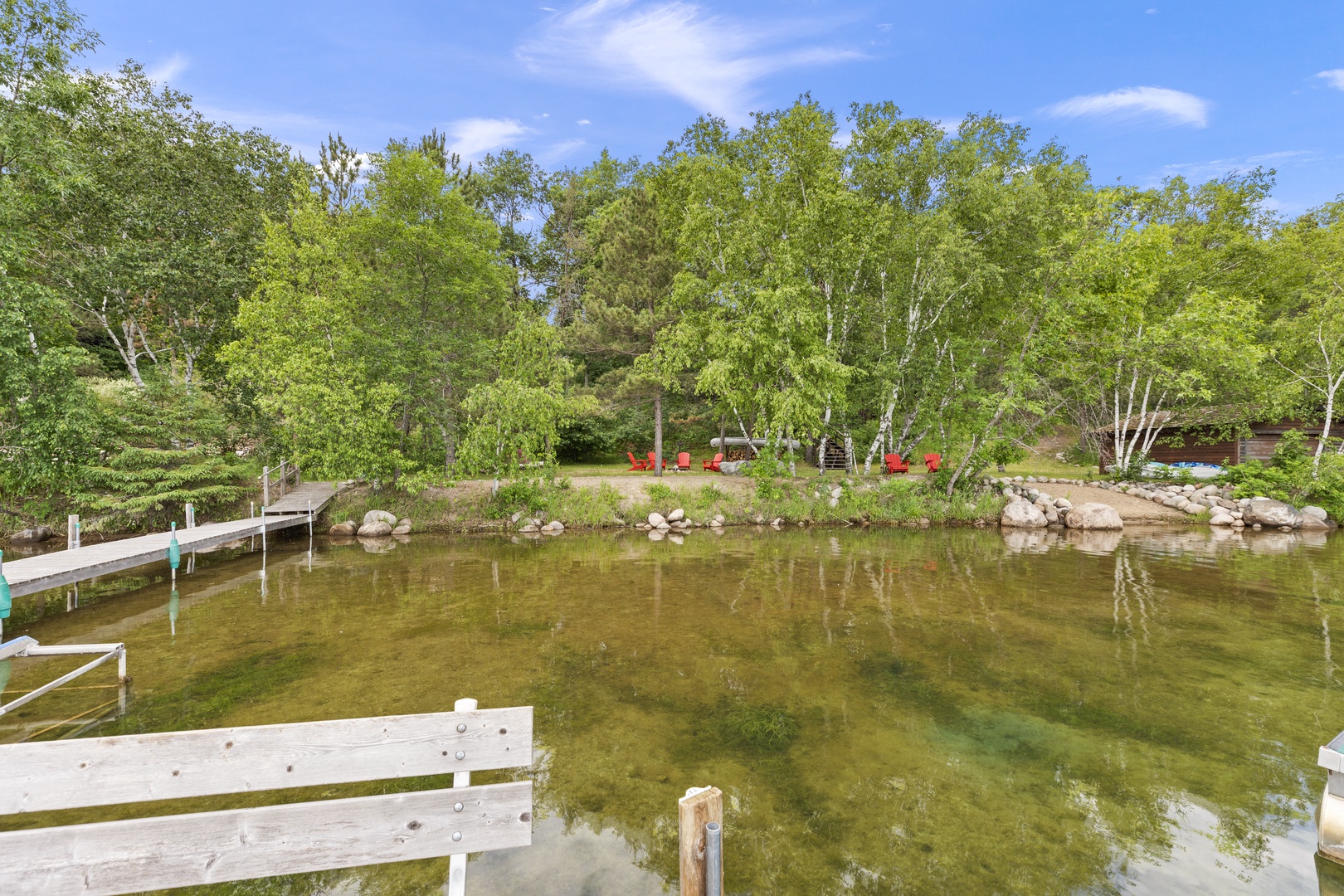 Peaceful lakefront setting with private dock, fire pit, and pontoon for rent