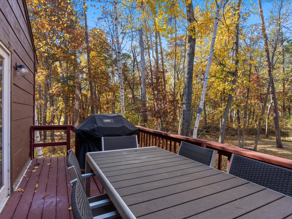 Deck has extra outdoor seating along with a grill