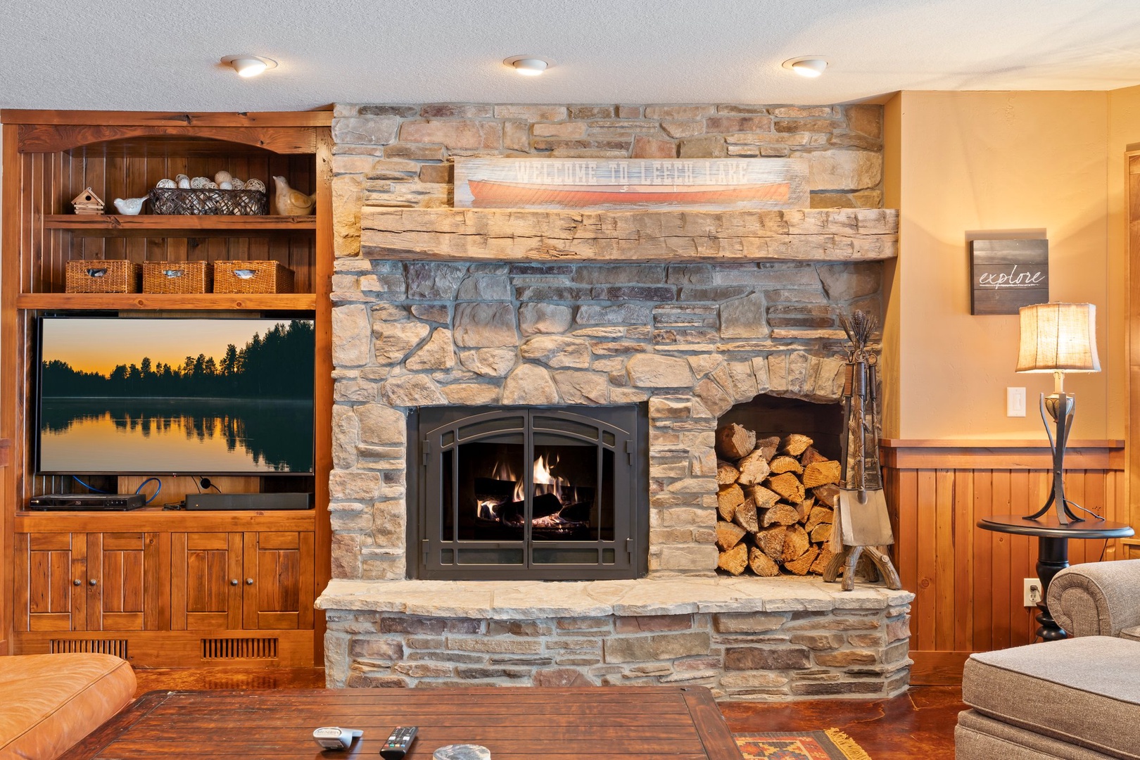 Cozy up by your crackling stone fireplace, surrounded by warm wood furnishings and thoughtful touches that make this space feel like home.