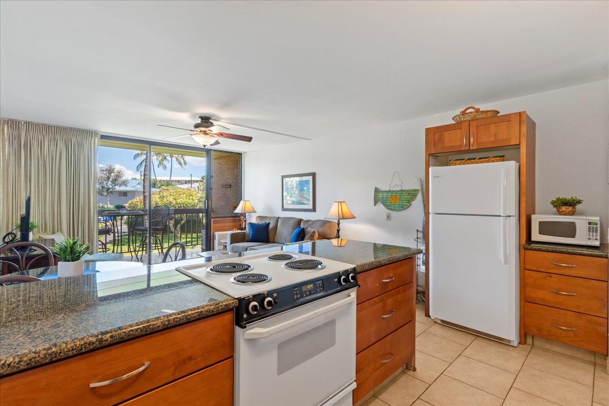 Step into your breezy island retreat, where the kitchen flows seamlessly into the living area and opens to a private balcony with palm tree views—your perfect spot for morning coffee and sunset cocktails.